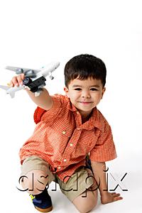 AsiaPix - Boy holding toy airplane, looking at camera