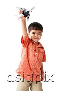 AsiaPix - Boy standing and holding toy airplane, looking at camera
