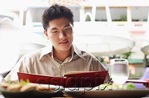 AsiaPix - Man in cafe, looking at menu