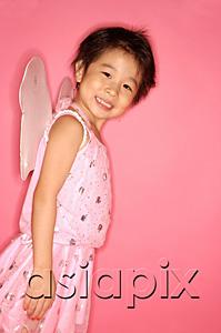 AsiaPix - Young girl in pink dress with wings attached, looking at camera, side view