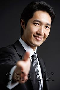 AsiaPix - Businessman, looking at camera, offering hand