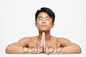 AsiaPix - Man with eyes closed, hands together