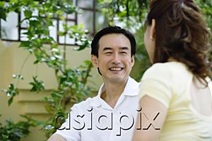 AsiaPix - Mature couple sitting, facing each other, smiling