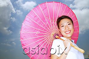 AsiaPix - Young woman with pink umbrella, smiling at camera