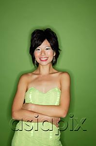 AsiaPix - Woman in green dress, arms crossed, smiling at camera