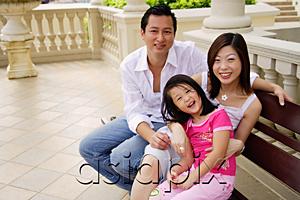 AsiaPix - Family with one child, sitting on bench, looking up at camera