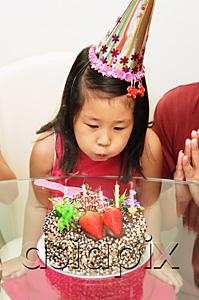 AsiaPix - Girl blowing out birthday cake