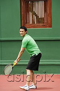 AsiaPix - Man serving a game of tennis on tennis courts