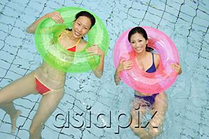 AsiaPix - Women in swimming pool, using inflatable rings, looking at camera