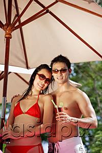 AsiaPix - Couple standing under umbrella, holding drinks
