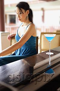AsiaPix - Woman sitting at bar counter