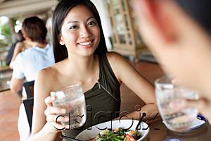 AsiaPix - Couple having a meal in restaurant, holding glasses of water