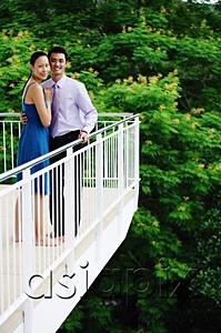 AsiaPix - Couple standing on balcony,  looking at camera