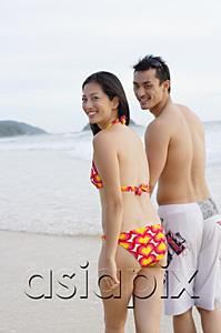 AsiaPix - Couple on beach, looking over shoulder at camera