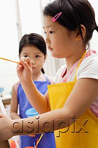 AsiaPix - Girl with paintbrush, another girl standing next to her