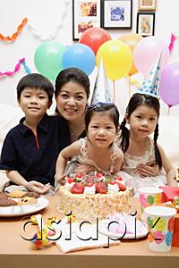 AsiaPix - Mother with three children celebrating a birthday