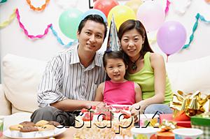 AsiaPix - Family with one child sitting with birthday cake, portrait