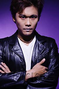 AsiaPix - Man in leather jacket and face paint, arms crossed