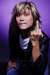 AsiaPix - Man in leather jacket and face paint, making rude hand gesture