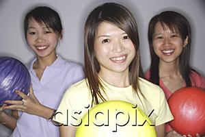 AsiaPix - Women holding bowling balls, smiling at camera