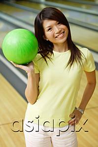AsiaPix - Woman at bowling alley with green bowling ball