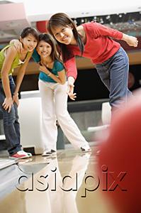 AsiaPix - Three women at a bowling alley, bowling ball in the foreground