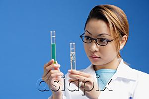 AsiaPix - Female technician looking at test tubes