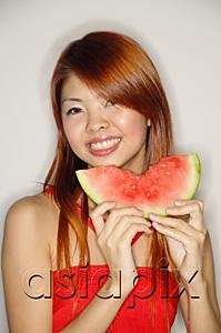 AsiaPix - Woman holding a slice of watermelon, smiling