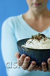 AsiaPix - Woman holding bowl of rice, selective focus