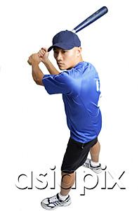 AsiaPix - Young man holding baseball bat, preparing to swing