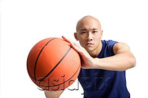 AsiaPix - Young man holding basketball, towards camera