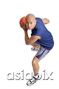 AsiaPix - Young man holding basketball