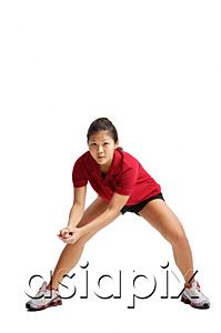 AsiaPix - Young woman bending down, waiting for volleyball