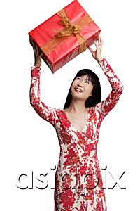 AsiaPix - Woman looking at gift wrapped box