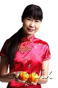 AsiaPix - Woman in Cheongsam, holding two oranges