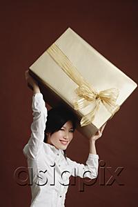 AsiaPix - Woman lifting big gift wrapped box
