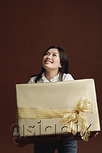 AsiaPix - Woman holding gold gift wrapped box