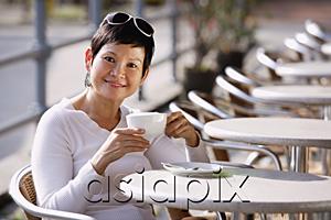 AsiaPix - Mature woman in cafe having a drink