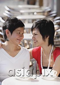 AsiaPix - Mother and adult daughter in cafe, smiling at each other