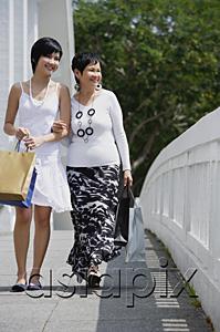 AsiaPix - Women walking arm in arm, along bridge