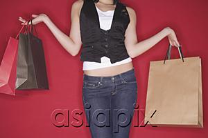 AsiaPix - Woman with shopping bags, mid-section