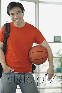 AsiaPix - Man in red T shirt and jeans, holding basketball
