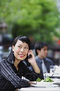 AsiaPix - Businesswoman at outdoor cafe, using mobile phone