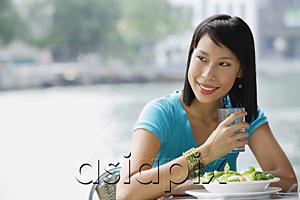 AsiaPix - Young woman in cafe, looking away, smiling