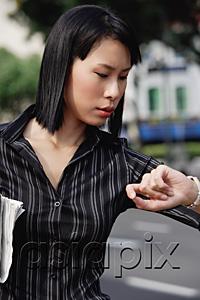 AsiaPix - Businesswoman checking the time