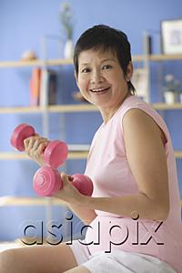 AsiaPix - Mature woman using dumbbells at home