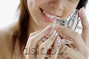 AsiaPix - Young woman with perfume bottle
