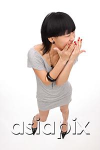 AsiaPix - Young woman looking away, hands over mouth
