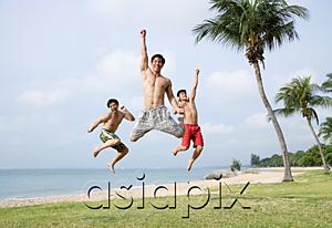 AsiaPix - Three men jumping in air, looking at camera