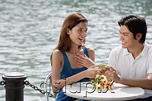 AsiaPix - Couple sitting at outdoor cafe, man giving woman a gift